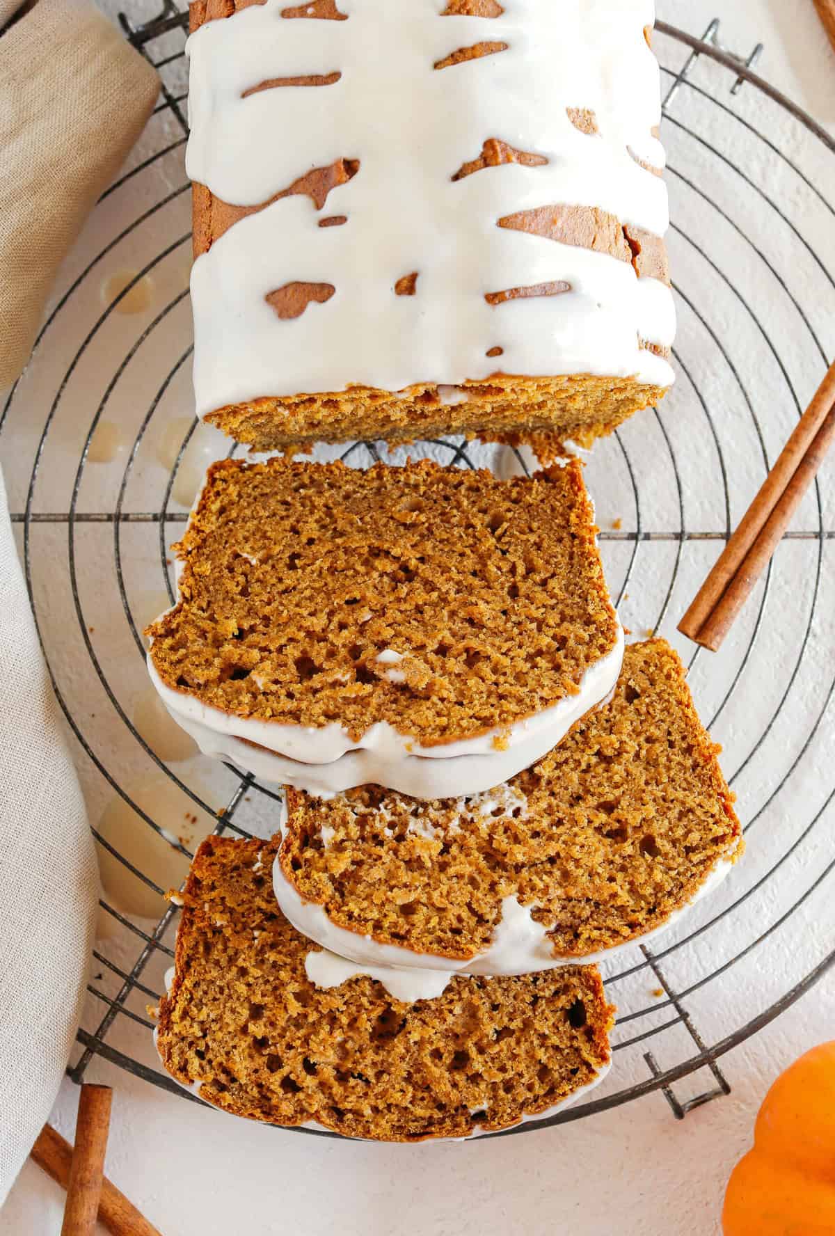 The BEST Healthy Pumpkin Bread recipe that is moist, loaded with pumpkin flavor and made without any butter or refined sugar! Topped with a delicious maple cream cheese glaze for the perfect fall treat this season!
