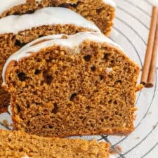 The BEST Healthy Pumpkin Bread that is moist, loaded with pumpkin flavor and made without any butter or refined sugar! Topped with a delicious maple cream cheese glaze for the perfect fall treat this season!