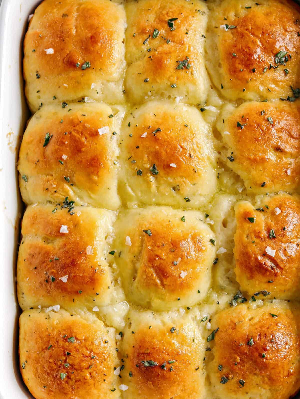 These pull-apart Honey Butter Dinner Rolls are light, fluffy and made without any yeast, eggs or oil. Infused with honey and fresh herbs, these Parker House-style dinner rolls are perfect for your holiday table this season!