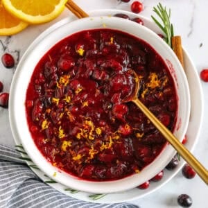 This Healthy Cranberry Sauce is naturally sweetened made with maple syrup, fresh orange juice, cinnamon, ginger and deep rich flavors from a little port wine. Sweet, tangy and the perfect addition to your Thanksgiving and Christmas table this season!