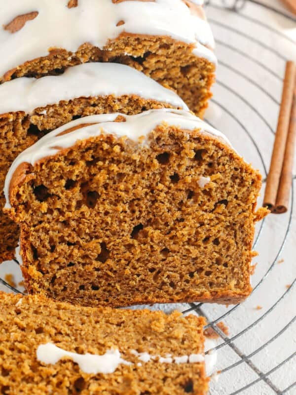 The BEST Healthy Pumpkin Bread that is moist, loaded with pumpkin flavor and made without any butter or refined sugar!  Topped with a delicious maple cream cheese glaze for the perfect fall treat this season!