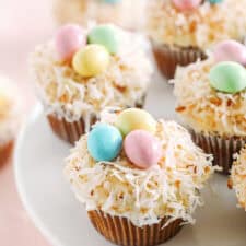 Celebrate Easter with these festive Bird's Nest Carrot Cake Cupcakes that are super moist, naturally sweetened with maple syrup and applesauce, all topped with a cream cheese frosting, toasted coconut and chocolate candies!