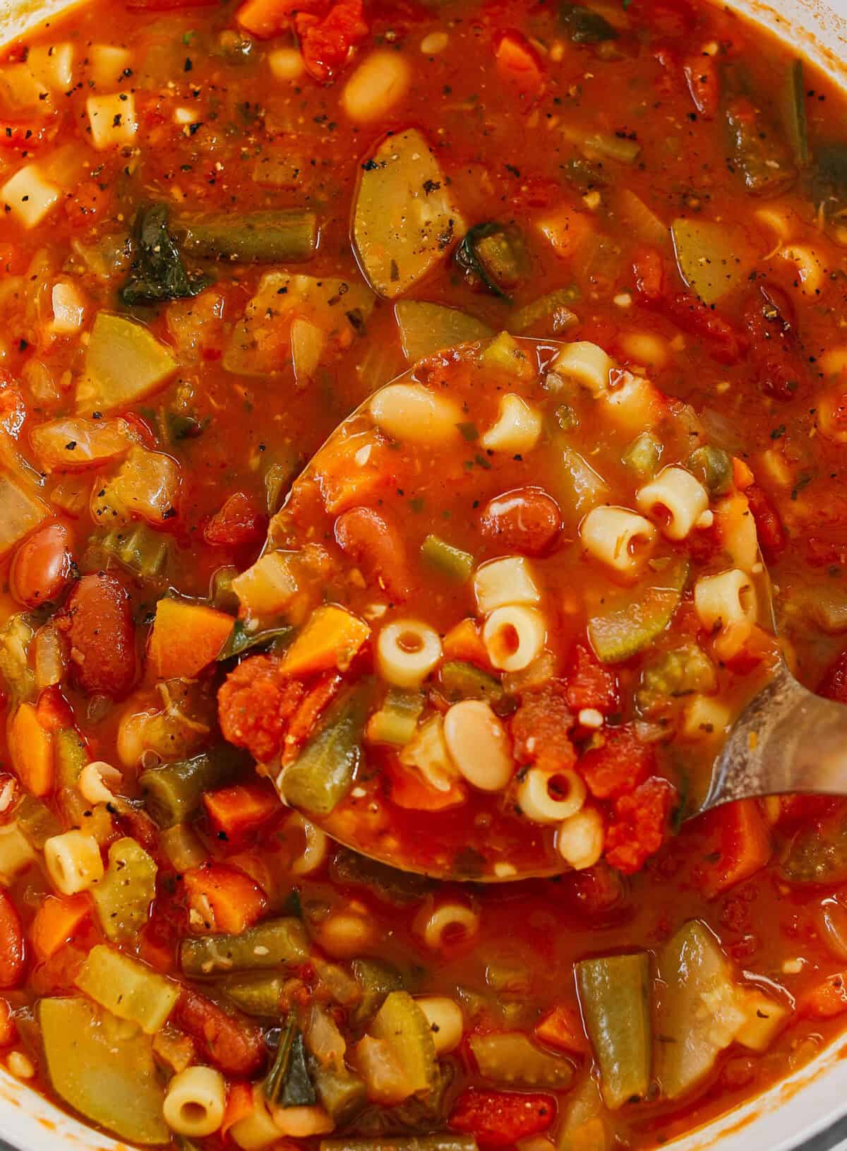 Easy and delicious Olive Garden Minestrone Soup loaded with fresh veggies, leafy greens and simmered in the most flavorful broth! Easily made in one pot for a cozy weeknight dinner the whole family will love!