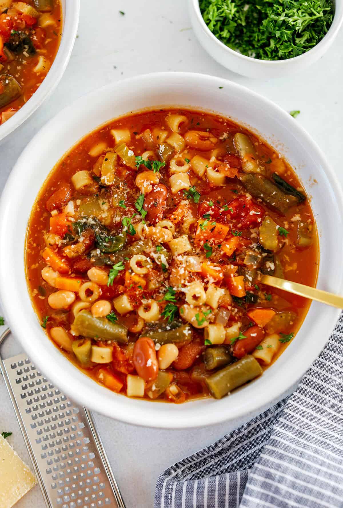 Easy and delicious Olive Garden Minestrone Soup loaded with fresh veggies, leafy greens and simmered in the most flavorful broth! Easily made in one pot for a cozy weeknight dinner the whole family will love!