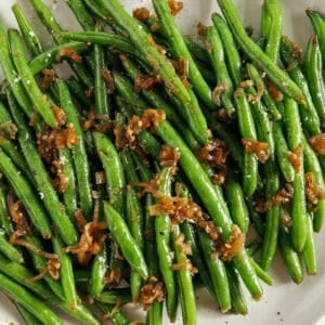 These fresh and crisp Garlicky Green Beans with Caramelized Shallots are a simple, healthy and flavorful side dish that comes together in just 15 minutes! No blanching necessary. Perfect for busy weeknights or served with a holiday meal.