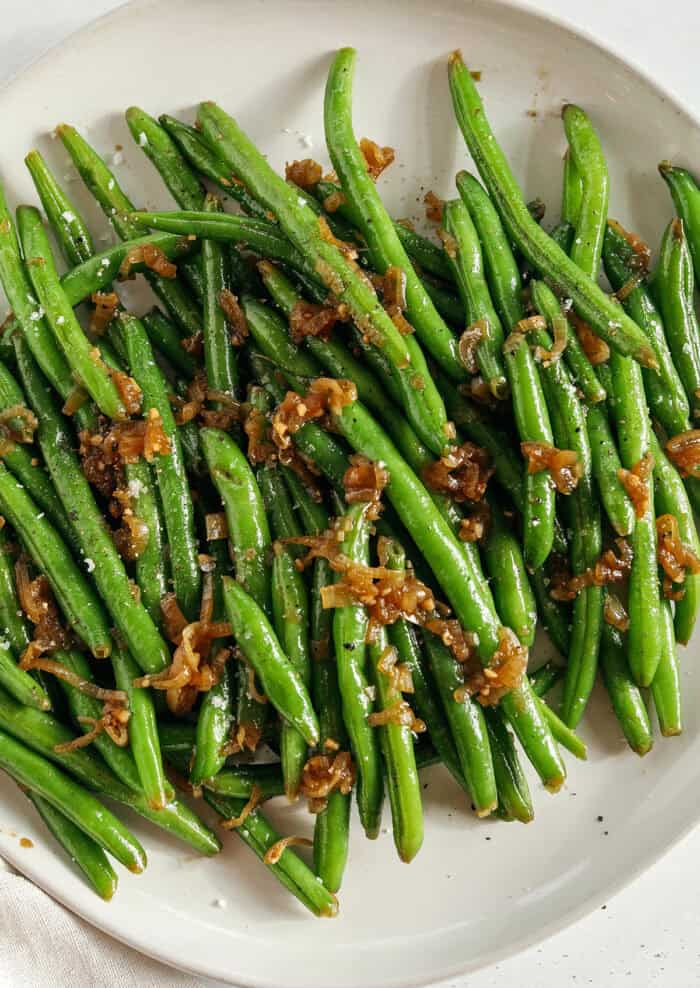 These fresh and crisp Garlicky Green Beans with Caramelized Shallots are a simple, healthy and flavorful side dish that comes together in just 15 minutes! No blanching necessary. Perfect for busy weeknights or served with a holiday meal.