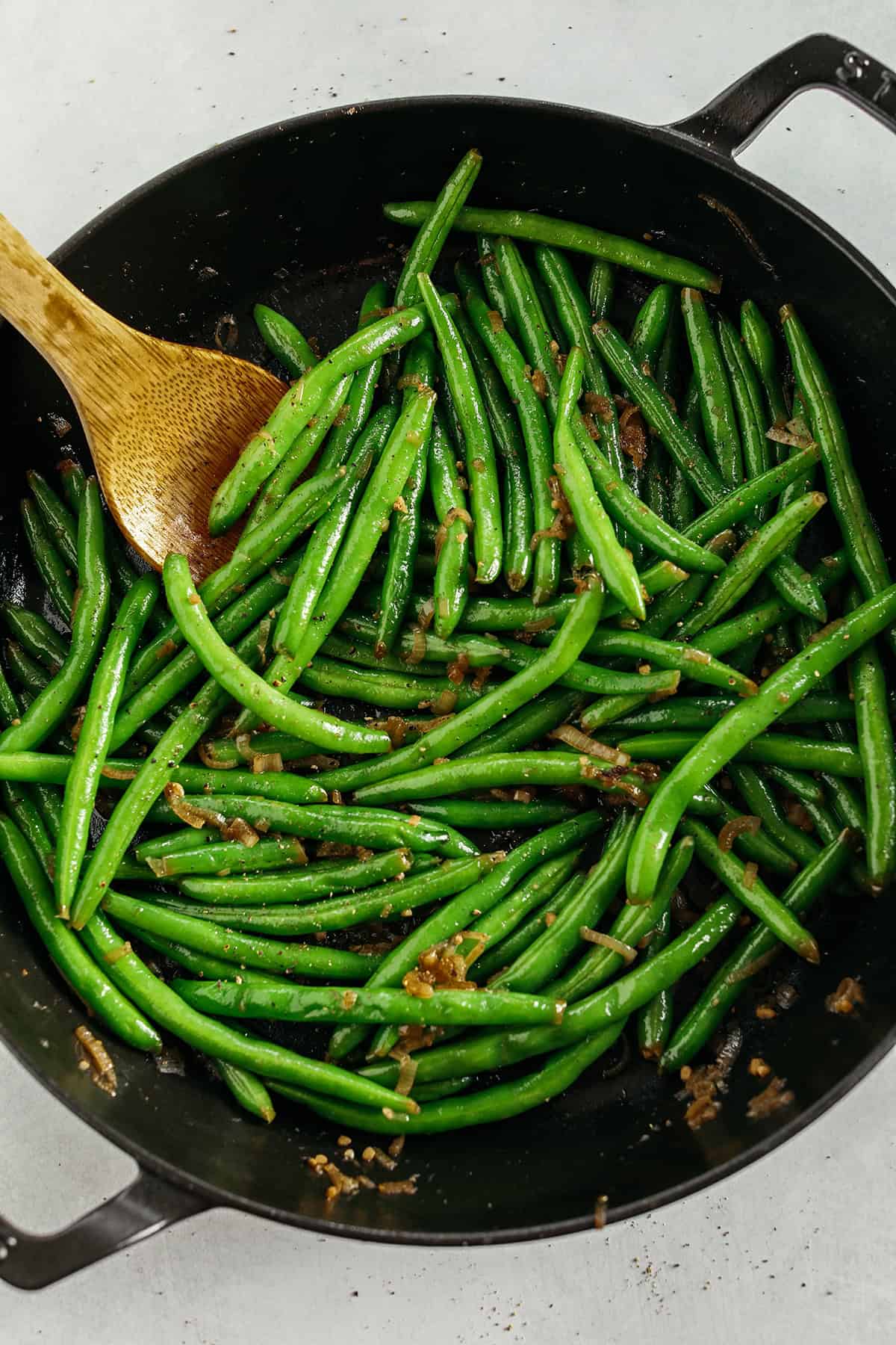These fresh and crisp Garlicky Green Beans with Caramelized Shallots are a simple, healthy and flavorful side dish that comes together in just 15 minutes! No blanching necessary. Perfect for busy weeknights or served with a holiday meal.