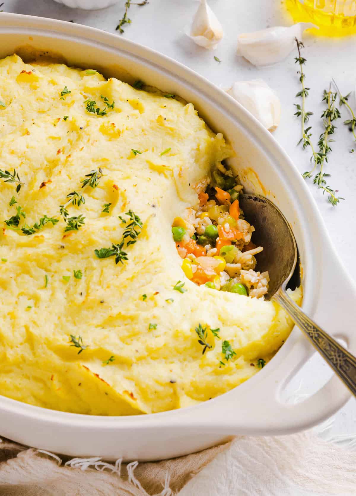 Cozy and delicious Healthy Turkey Shepherd's Pie Recipe made with lean ground turkey, colorful vegetables, rich homemade gravy and topped with lighter mashed potatoes. A healthier twist on a classic comfort food dish the whole family will love!