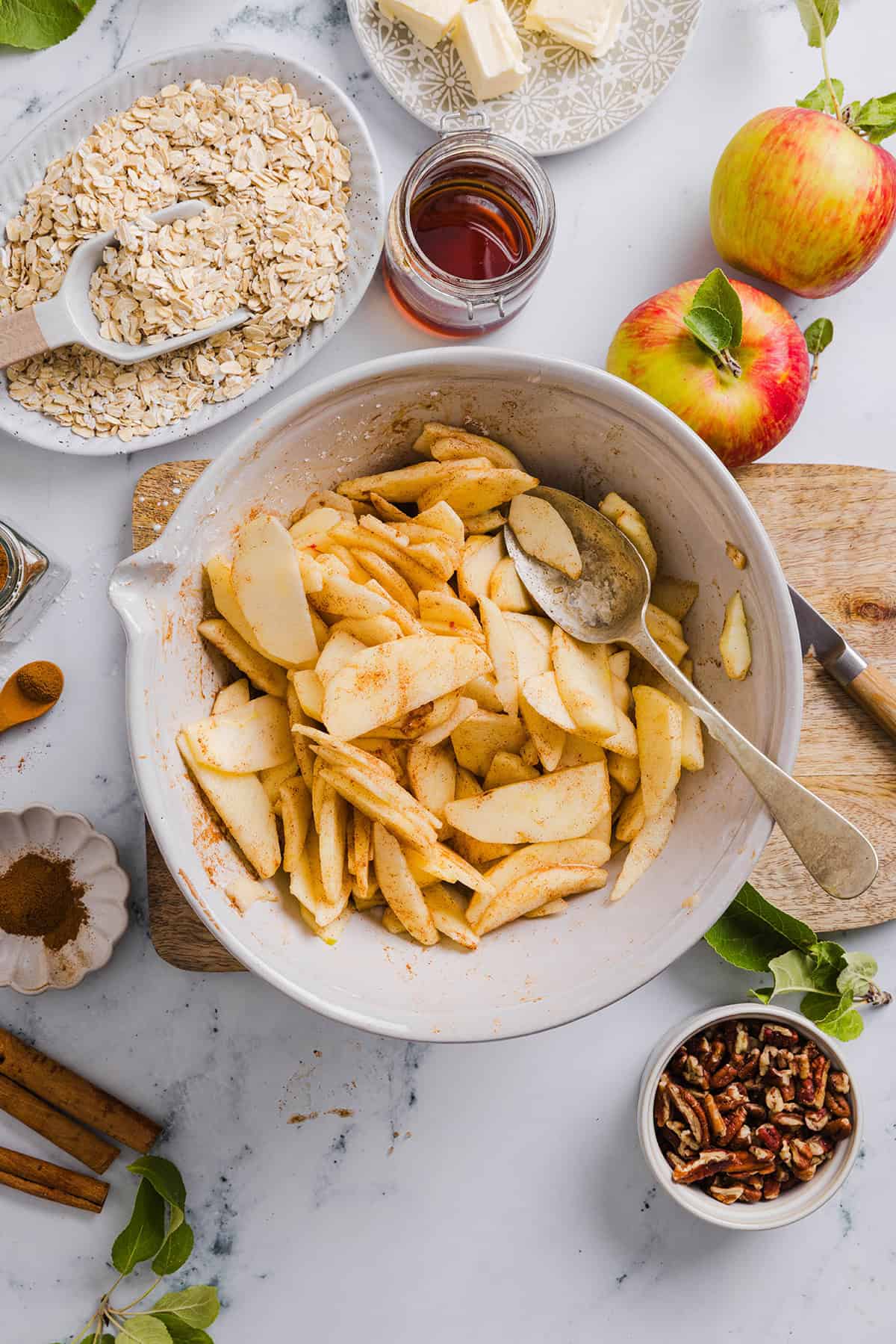 This Healthy Apple Crisp is loaded with tender apples and warm spices, naturally sweetened with maple syrup, all topped with a crunchy oatmeal pecan topping for the perfect fall dessert!