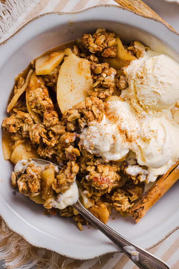 This Healthy Apple Crisp is loaded with tender apples and warm spices, naturally sweetened with maple syrup, all topped with a crunchy oatmeal pecan topping for the perfect fall dessert!