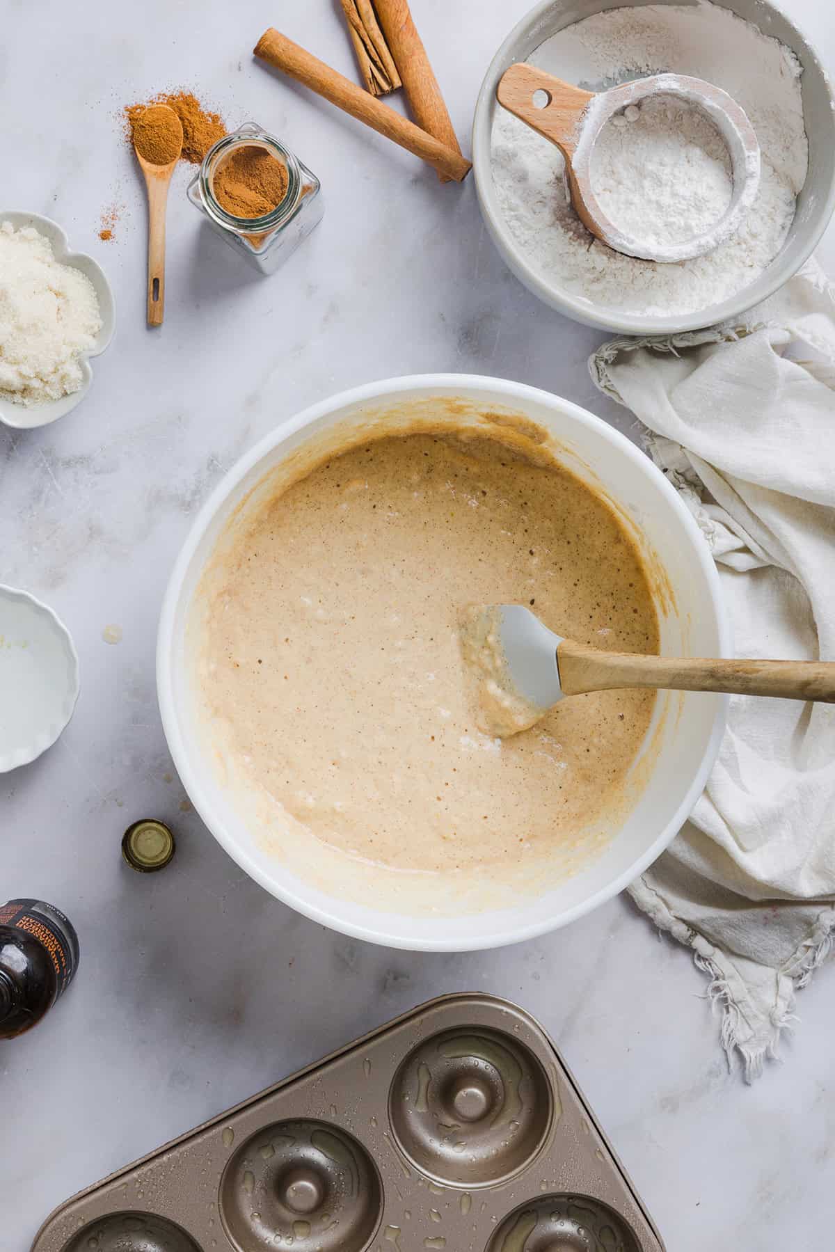 Soft Baked Apple Cider Donuts made healthier with whole wheat flour, applesauce and Greek yogurt for the perfect fall treat that comes together in just 20 minutes!  Loaded with warm spices and coated with cinnamon and sugar!