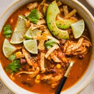 This Easy Chicken Tortilla Soup makes the perfect weeknight meal that can easily be made right in your instant pot, slow cooker or on the stove! Packed with tender shredded chicken, veggies, beans and all the toppings for a delicious, flavor-packed meal!