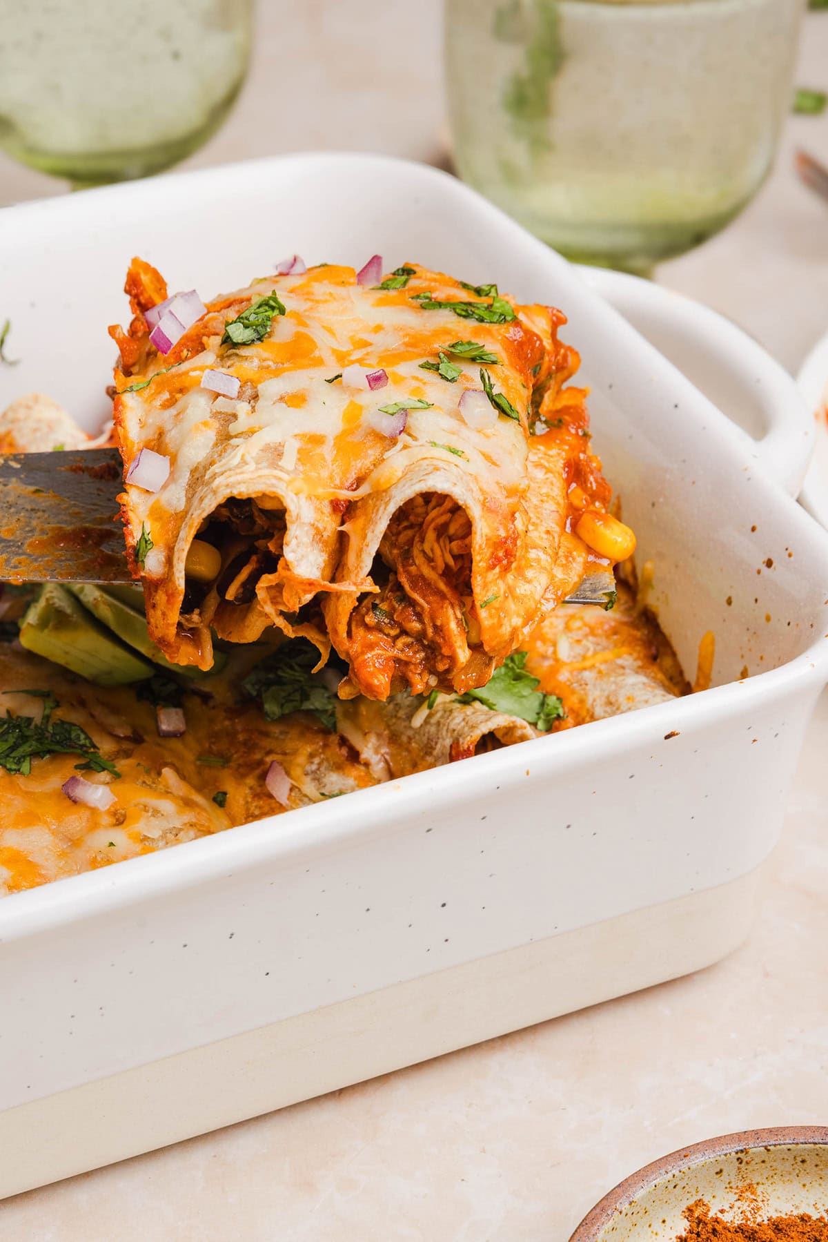 This Healthy Chicken Enchilada recipe is a family favorite made with wholesome, flavorful ingredients for the perfect weeknight meal! The homemade enchilada sauce tastes absolutely amazing! 