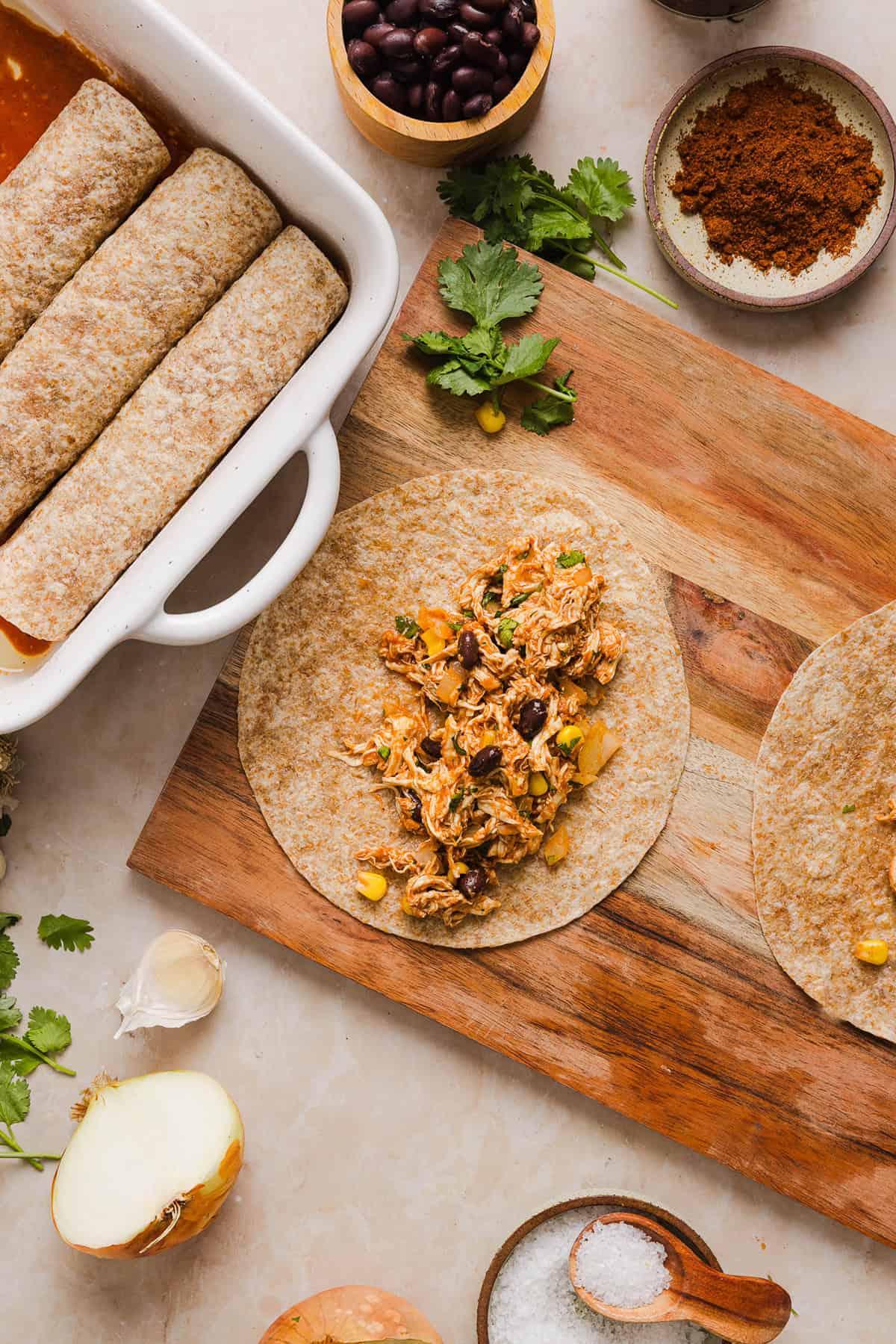 This Healthy Chicken Enchilada recipe is a family favorite made with wholesome, flavorful ingredients for the perfect weeknight meal! The homemade enchilada sauce tastes absolutely amazing! 